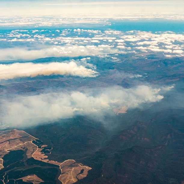 Flying over the bushfires at on my way to the USA. Down below: the border between NSW and Victoria, somewhere in the top right is Mallacoota. I watched as fire after fire added up until eventually the entire sky below me was a layer of smoke... clouds above, smoke below.